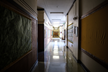 an empty hallway is picture as students shift from campuses to online technology for school