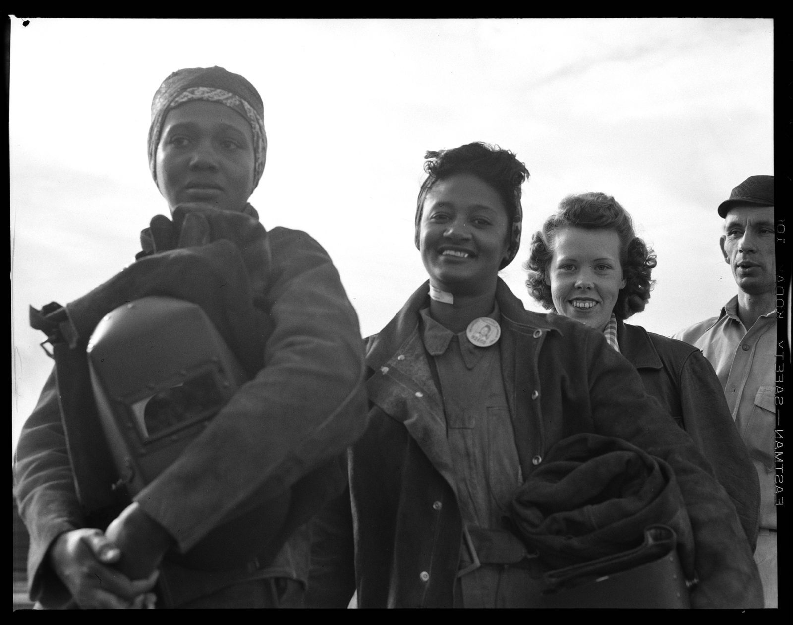 Women line up for paychecks-Richmond Shipyards Richmond, CA, Circa 1942. Dorothea Lange. Film negative, Gift of Paul S. Taylor 5 in x 4 in., A67.137.42080.4 © The Dorothea Lange Collection, the Oakland Museum of California. Digitized for the Oakland Museum of California 2019 Luce Grant